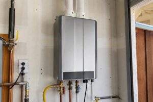Tankless water heater installed on a residential utility wall with gas and water lines
