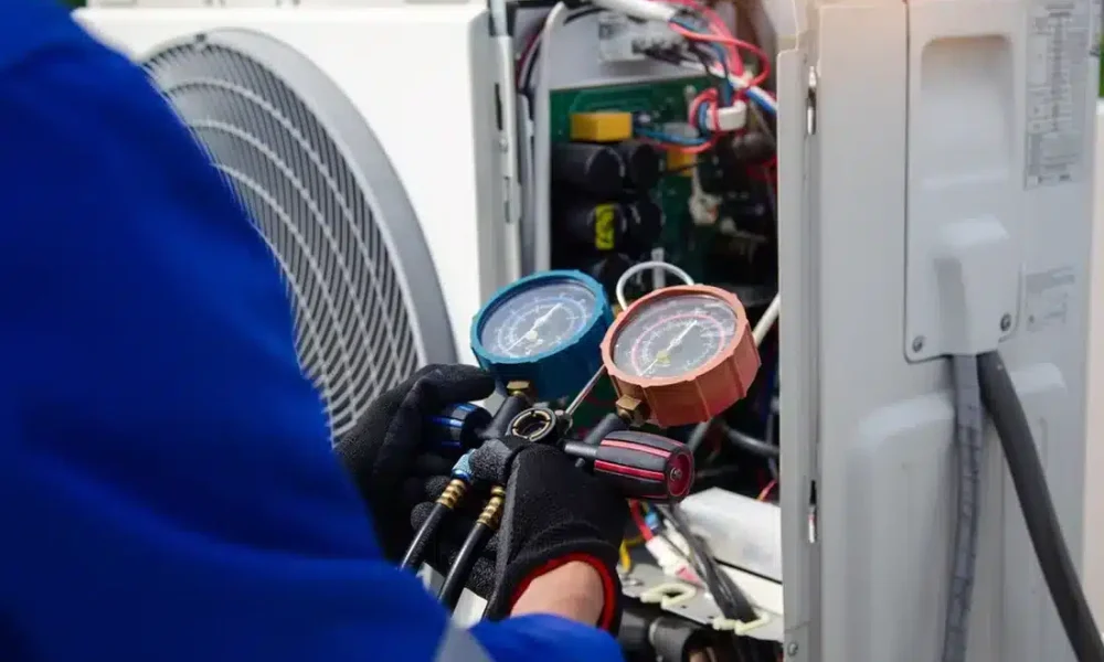 HVAC technician servicing outdoor heat pump equipment in Oshawa